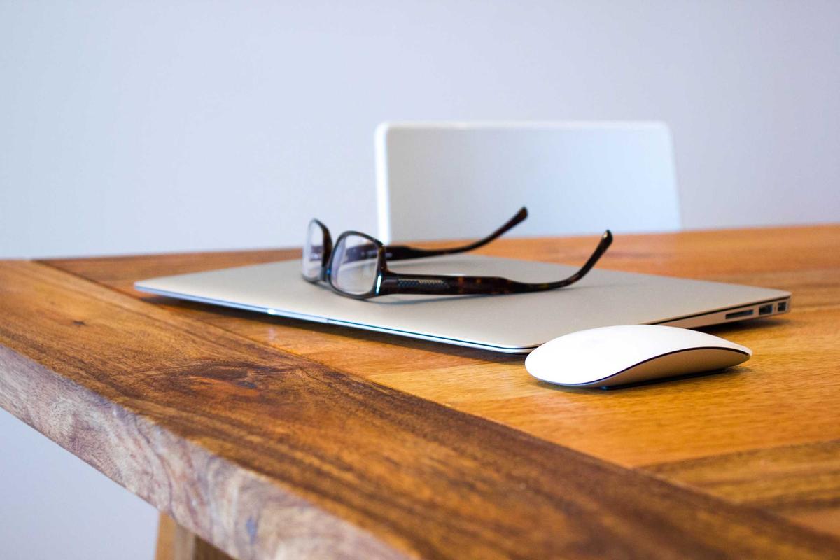 A person working on a laptop with a digital ebook cover titled how to make a living with your writing pdf